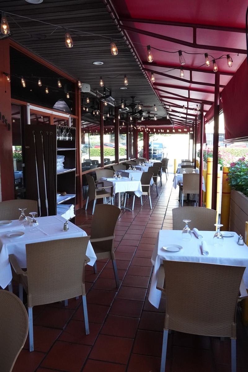 The Casa Mia patio set for a group celebration with long rows of white tablecloths