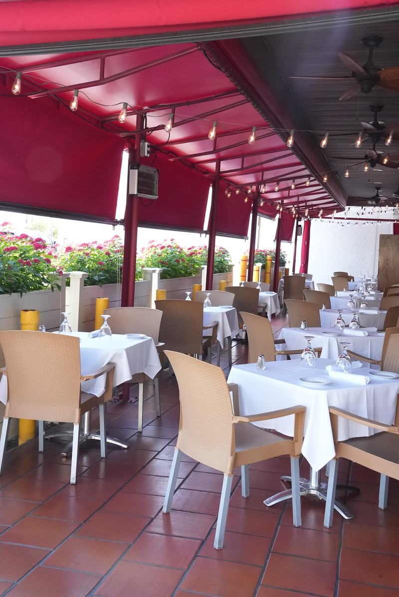The red awning patio at Casa Mia Trattoria in North Miami in the evening